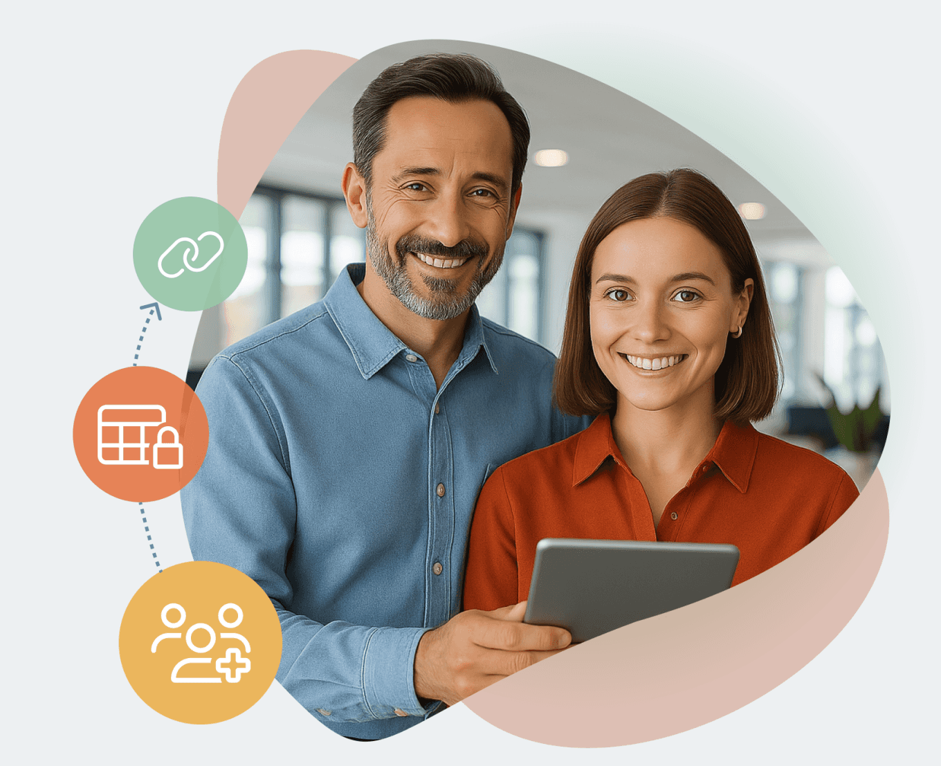 Two people standing in a bright office, smiling and holding a tablet.