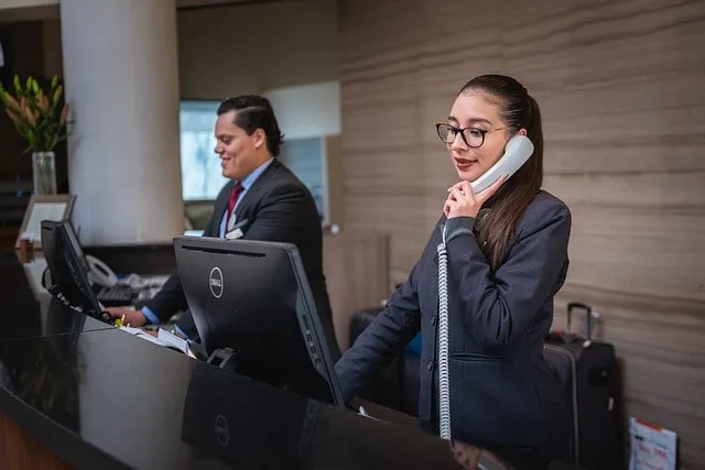 receptionists, phone call, hotel, reception, woman, man, work, attention, lobby, employees, professional, company, assistance