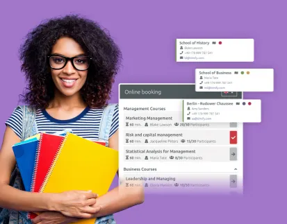 a woman with a lot of folders laughing into the camera